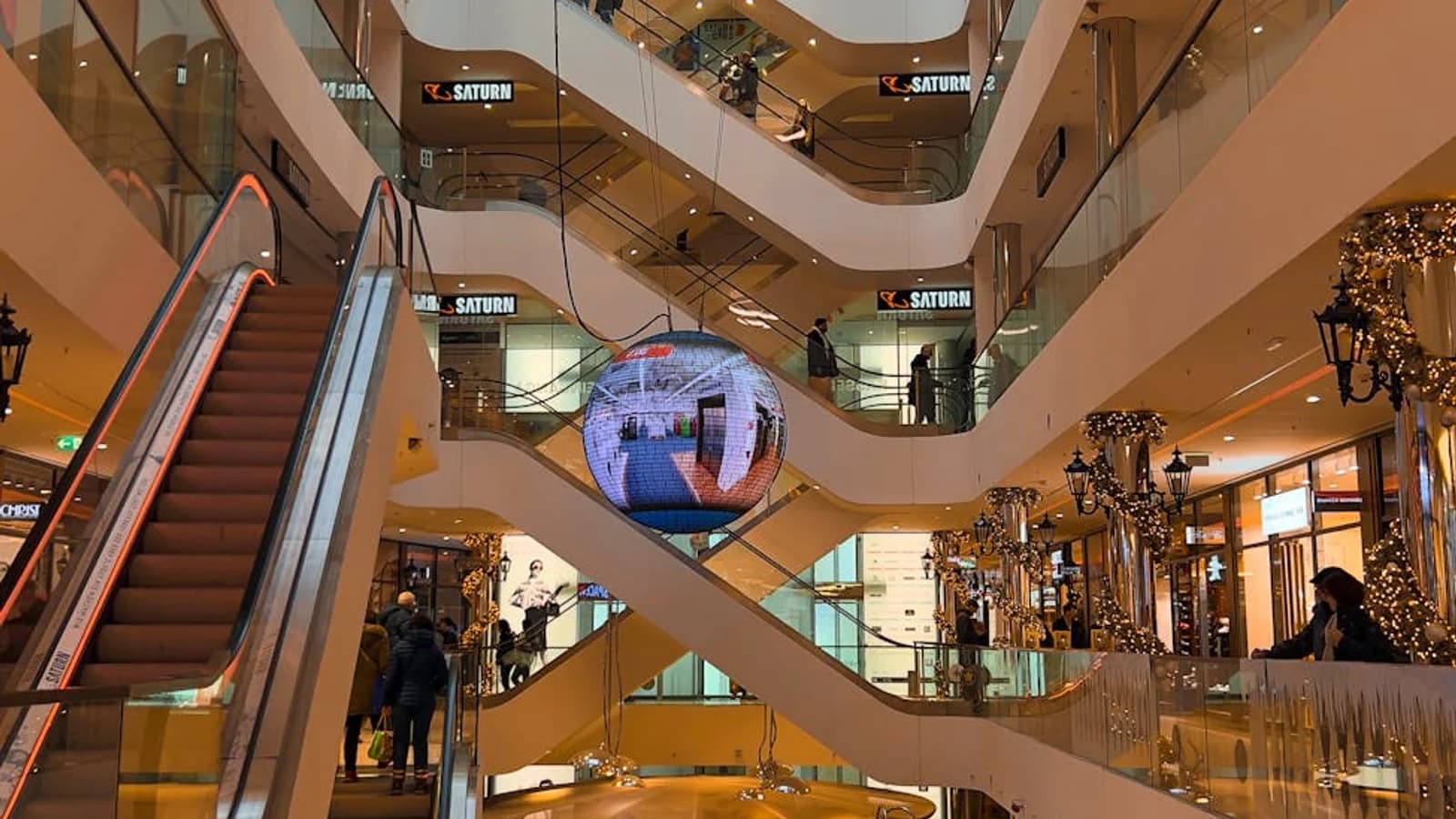 Shopping mall entrance with calibrated traffic spillover into interior corridors