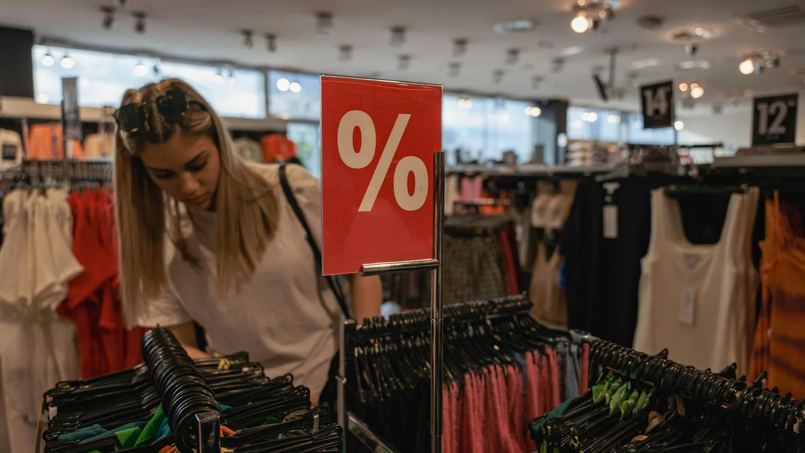 Modern retail floor with shoppers moving through merchandising zones