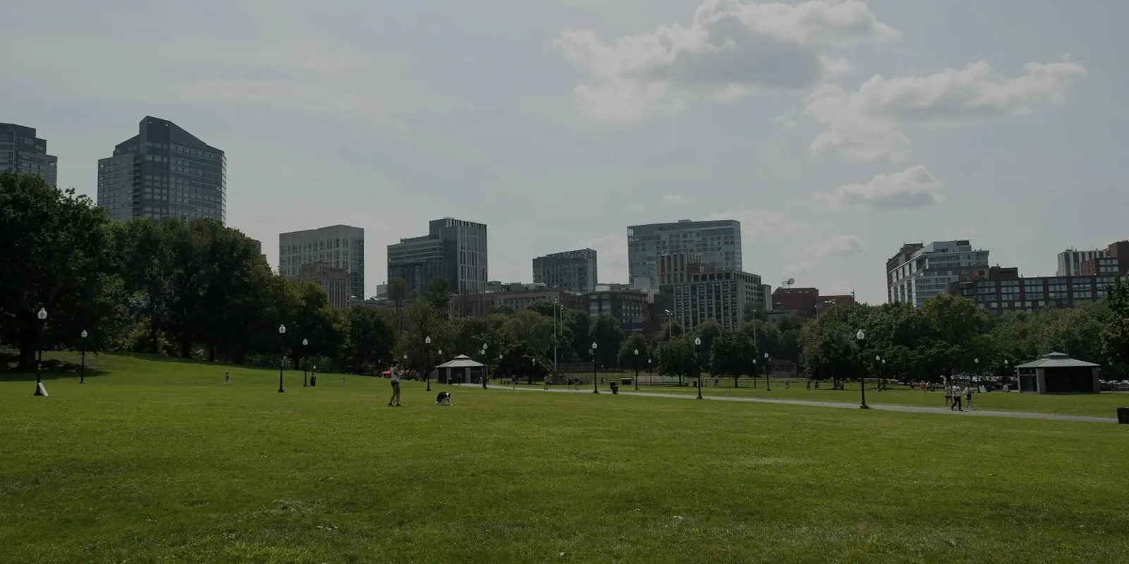 Crowd moving through a busy public square in a city